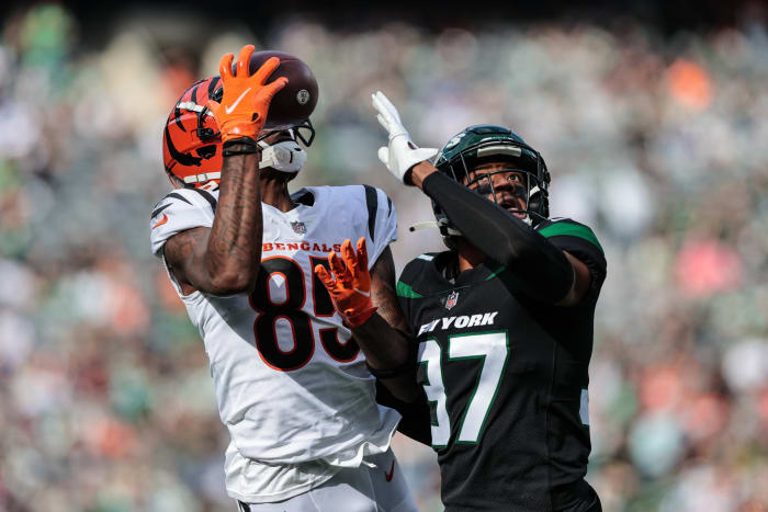 Oct 31, 2021; East Rutherford, New Jersey, USA; Cincinnati Bengals wide receiver Tee Higgins (85) catches the ball as New York Jets cornerback Bryce Hall (37) defends during the first half at MetLife Stadium.